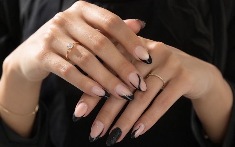 edgy black french tip almond nails 2026 designs on nude base
