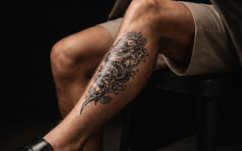 Fully healed shin tattoo on male leg close-up
