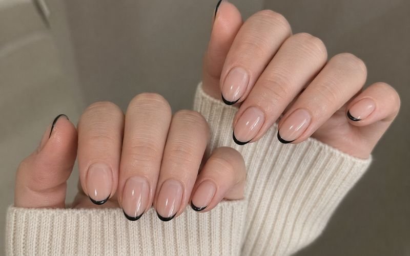 minimal black french tip almond nails thin tips