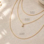three layered gold necklaces of different lengths flat lay