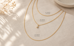 three layered gold necklaces of different lengths flat lay