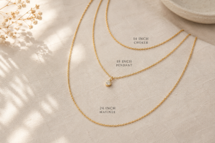 three layered gold necklaces of different lengths flat lay